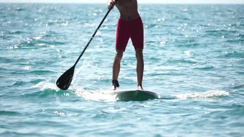 Man Sup Sea Strong Athletic Man Learns to Paddle Sup Standing on Board in Open Sea Ocean on Sunny