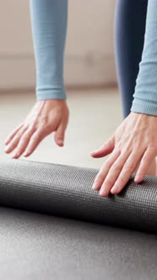 Roll, start and hands of woman with yoga mat for holistic exercise, wellness and health in studio