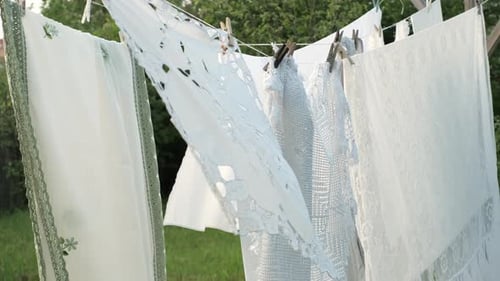 White Linens Drying on Clothesline Outside