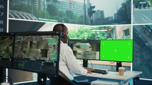 African American Employee Using CCTV Security System and Mockup Screen