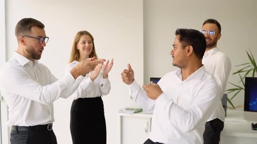 Team Cheers and High-Fives in Modern Office