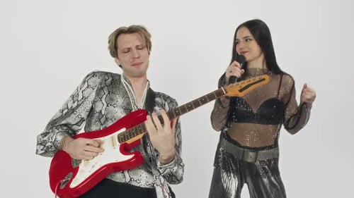 Bass Player Rocking out with Front Woman While Making Music Clip in Studio