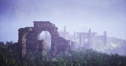 Ruins of an Ancient Structure Surrounded By Mist and Greenery at Dawn