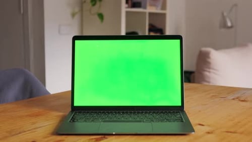 Laptop Computer with Green Screen Chroma Key Mockup on Working Desk in Office with No People