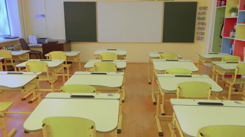 Empty Classroom with Desks and Whiteboard
