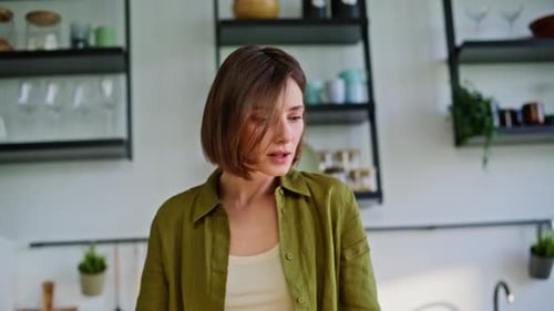 Woman Cuts Salad, Drinks Coffee in Sunny Kitchen