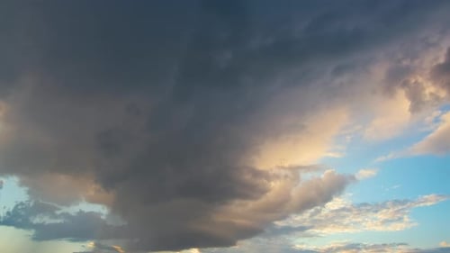 Dark Stormy Clouds on Yellow Sky at Sunset