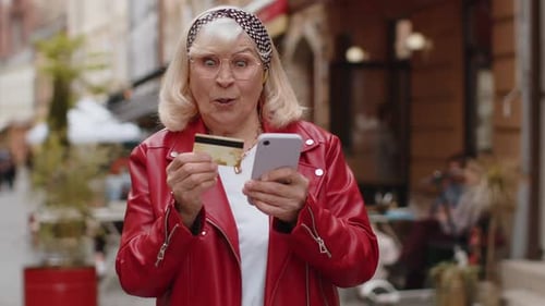 Senior Woman Using Credit Bank Card Smartphone While Transferring Money Purchases Online Shopping