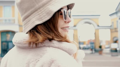 Stylish Woman Walking Down a City Street