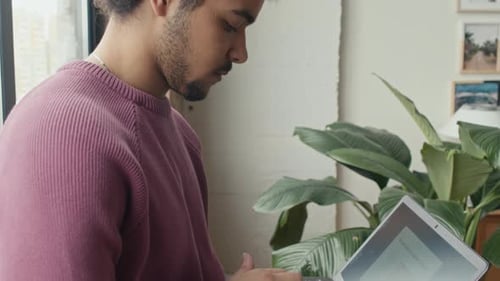 Young IT Specialist Working on Laptop in Office