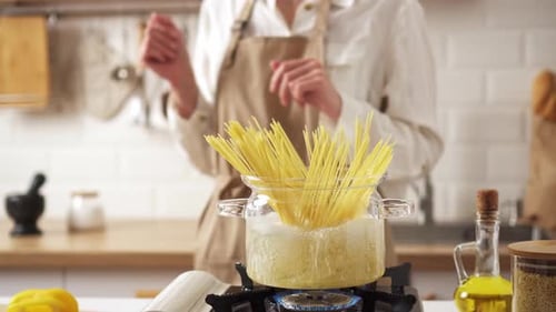 Cooking Pasta in a Pot Inside of a Home