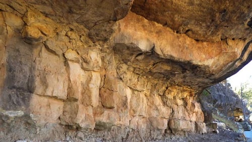 Sandstone Walls Of Cave Dwellings At Walnut Canyon By Trail Path. Slow Dolly Right