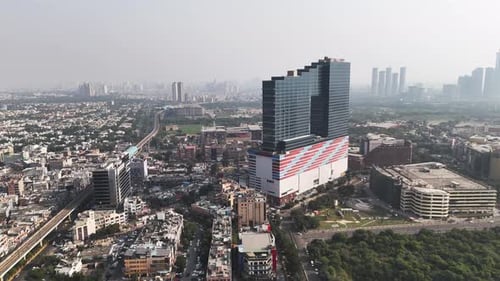 Aerial footage of sleek high-rise offices, bustling intersections, and planned urban spaces come