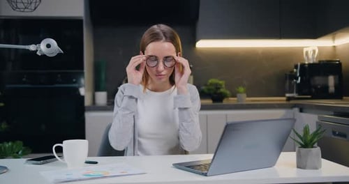 Attractive adult business woman typing on laptop computer working in internet at home office. Female