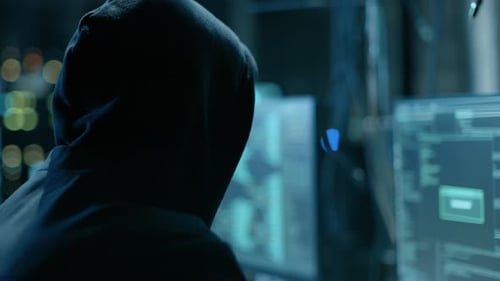 Hacker Coding at Multiple Computers in Dark Room