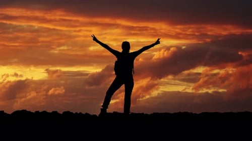Silhouette of Hiker Celebrating Sunset Success