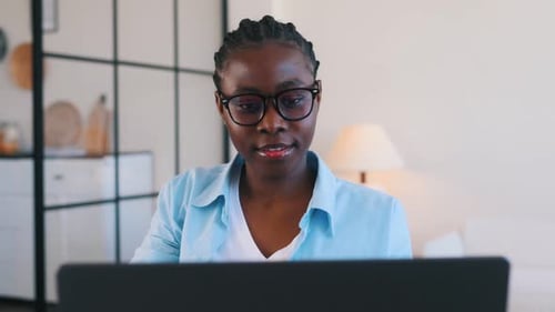 Young Woman Working on Laptop in Bright Home
