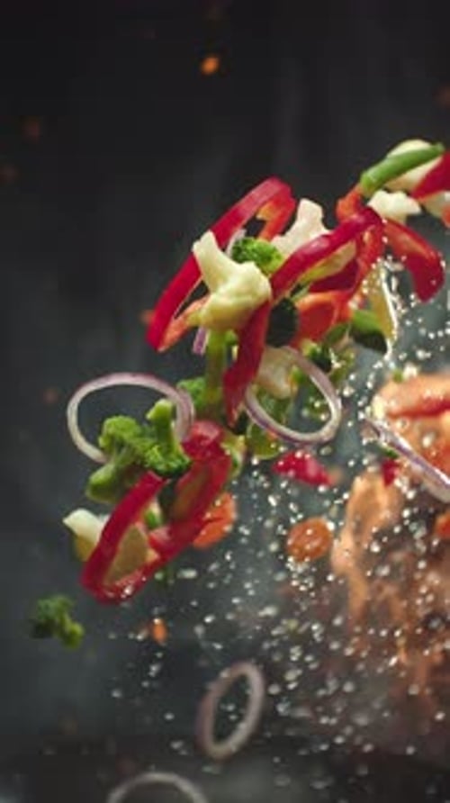Colorful Vegetables Sizzle in Wok with Flames