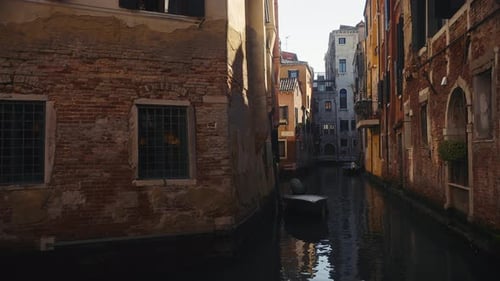 Water Canal with Boats Moored Near Residential Buildings in Venice