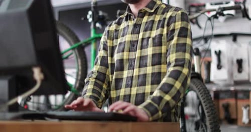 Small business owner using computer in a store