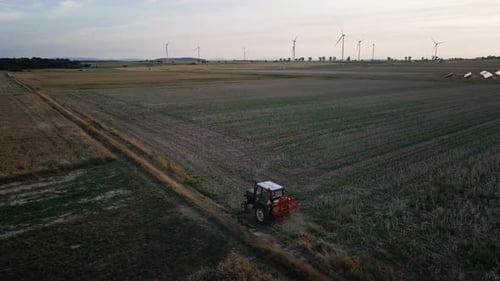 Small Tractor Cultivating Soil at Agricultural Field Aerial View