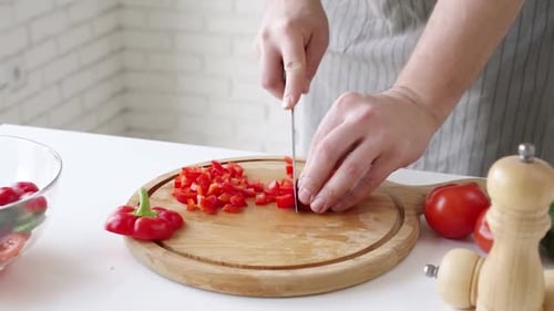 Hands Cutting Red Bell Pepper for Salad