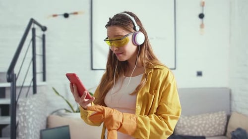 Young Woman Use Phone Feel Wonder While Cleaning the Floor at Home Apartment Hygiene Indoors