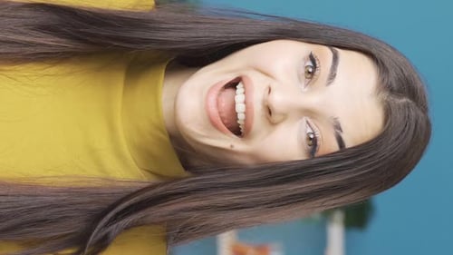 Vertical Video Of Confused young woman is astonishingly rejoicing and happy.