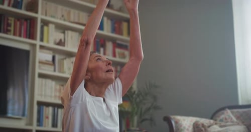 Woman Doing Yoga in Living Room at Home