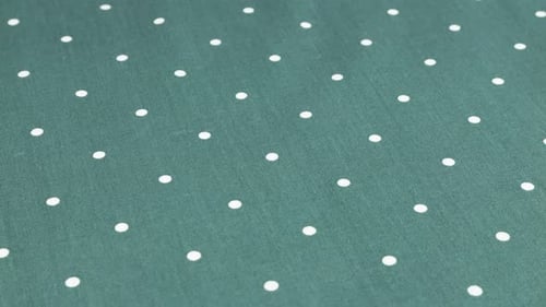 Top view of the queen blue with white polka dots cotton fabric rotated on the display case