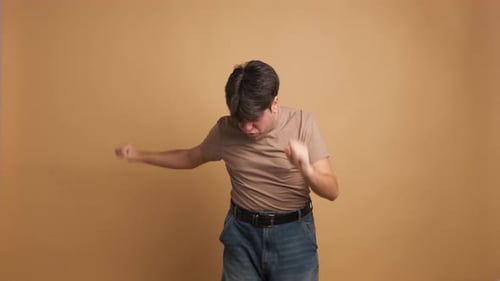 Casual Young Man Jumping and Dancing Celebrating