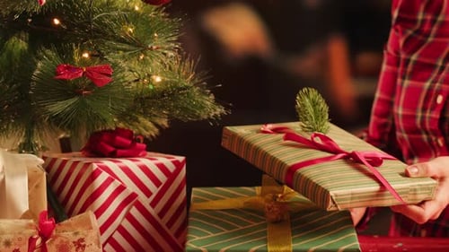 Friends Giving Presents to Each Other Top View Celebrating New Year Sitting at Dining Table