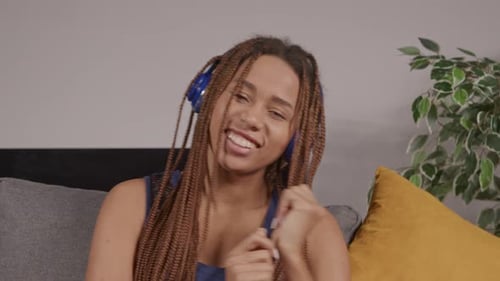 Woman Enjoys Music with Headphones Indoors