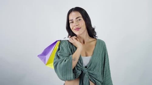 Smiling latina woman with shopping bags and credit card