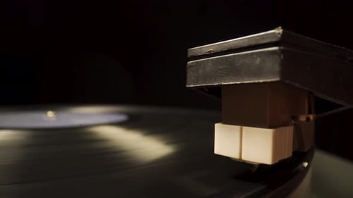 Close up shot of a turntable with a record spinning on it playing music