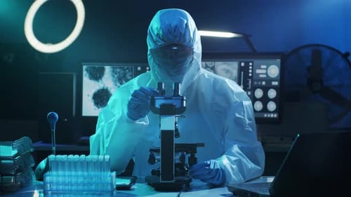 Scientist Works With Microscope in Futuristic Lab