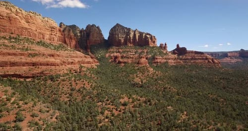 Aerial rotation flying into red rock formations in Sedona, Arizona