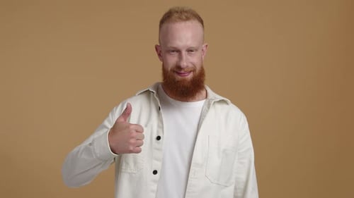 Smiling Man with Red Beard Gives Thumbs Up