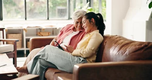 Senior Woman and Young Woman Looking at Tablet
