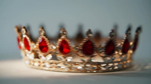 Gold crown adorned with sparkling red jewels