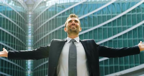 successful man under a skyscraper smile and breath for business and marketing. concept of freedom