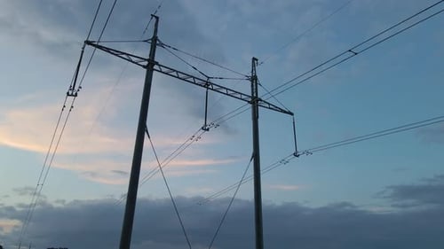 Dark Silhouette of High Voltage Tower with Electric Power Lines at Sunset Transfer of Electricity