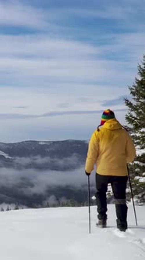 Winter Hiking Adventure in a Snowy Mountain Landscape with Bright Blue Sky