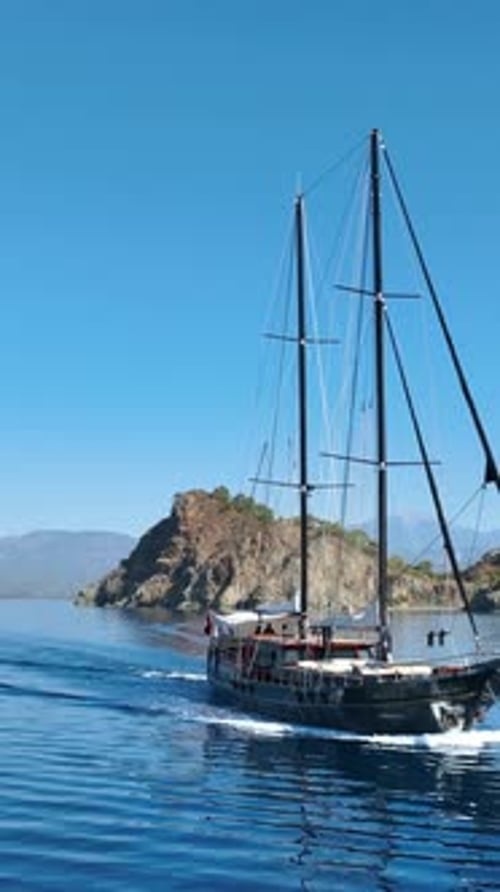 Vertical aerial shot of gulet in summer sea