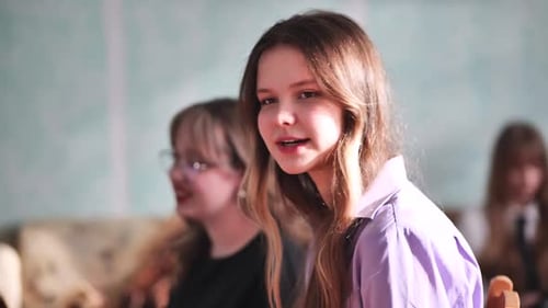 Smiling Teenager Talking with Classmates Indoors