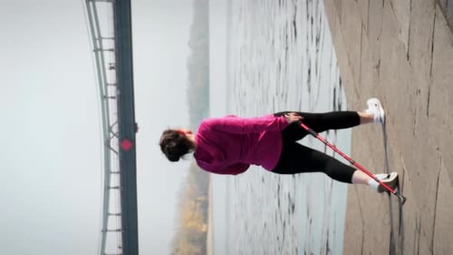 Follow view of chubby female training with nordic walking poles