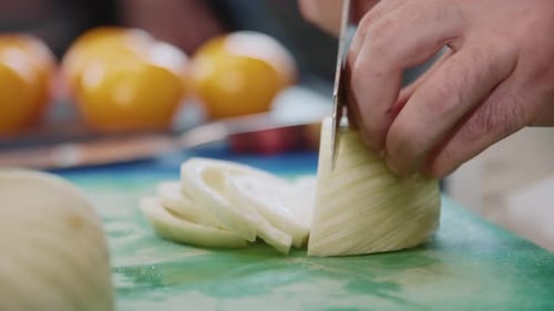 Closeup Slow Motion View of Man Cutting Onion with Knife Male Hands of Chef Cooking Soup Healthy