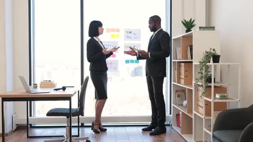 Business People Discussing Charts in Modern Office