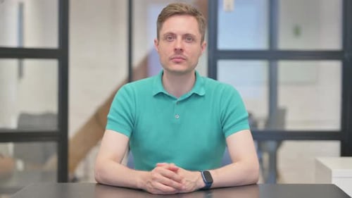 Mature Adult Man Looking at Camera in Office