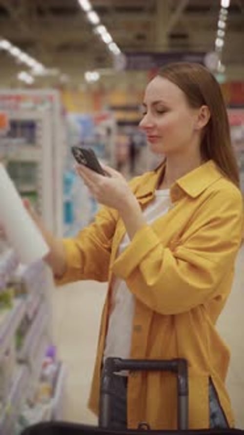 Choosing the Right Shampoo at a Local Store While Checking Product Details on a Phone